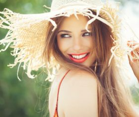 Woman wearing a sunshade straw hat Stock Photo