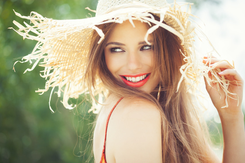 Woman wearing a sunshade straw hat Stock Photo