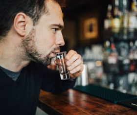 Young man drinking at the bar Stock Photo 01