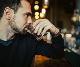 Young man drinking at the bar Stock Photo 02