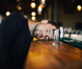 Young man drunk in the bar Stock Photo