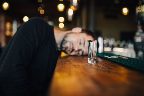 Young man drunk in the bar Stock Photo