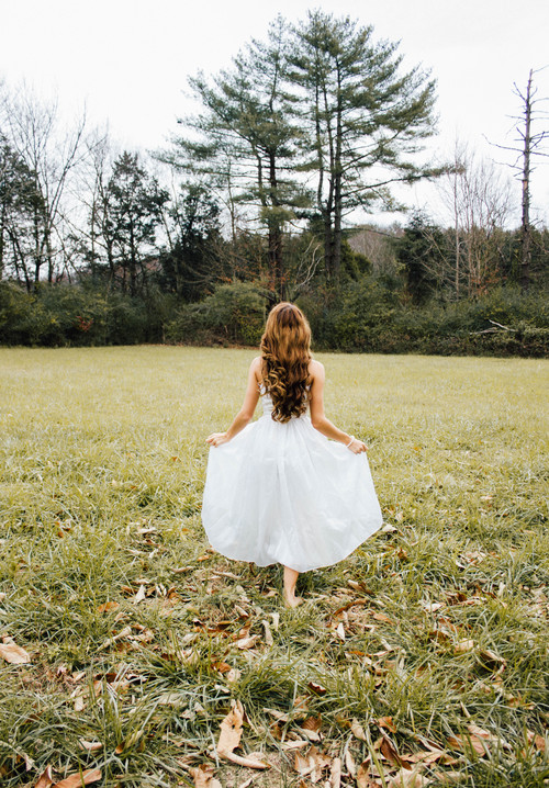 woman in white dress outdoors Stock Photo