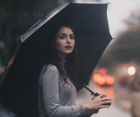 Beauty hold up an umbrella on rainy days Stock Photo