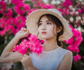 Cheerful bright makeup girl holding flowers Stock Photo