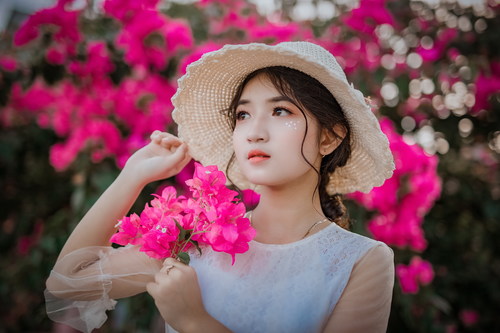 Cheerful bright makeup girl holding flowers Stock Photo