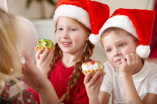 Child wearing christmas hat eating cake Stock Photo 03