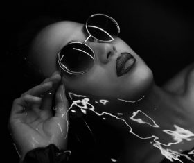 Fashion woman lying in the water shooting Stock Photo