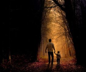 Father and son walking in the woods trail Stock Photo