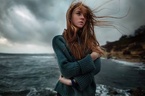 Girl blowing the sea breeze Stock Photo