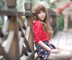 Girl sitting on the wooden bridge posing Stock Photo