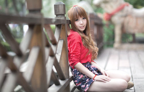 Girl sitting on the wooden bridge posing Stock Photo