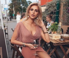 Graceful woman sitting in open air cafe Stock Photo