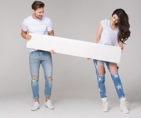 Happy couple holding white board Stock Photo 01