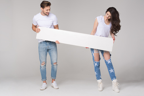Happy couple holding white board Stock Photo 01