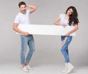 Happy couple holding white board Stock Photo 02