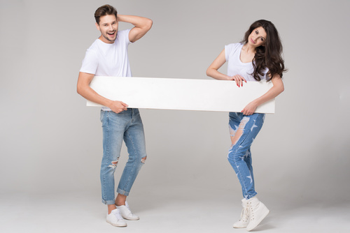 Happy couple holding white board Stock Photo 02