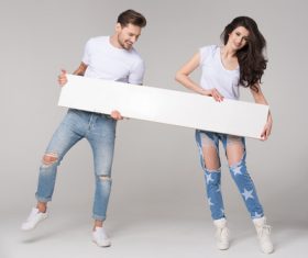 Happy couple holding white board Stock Photo 03