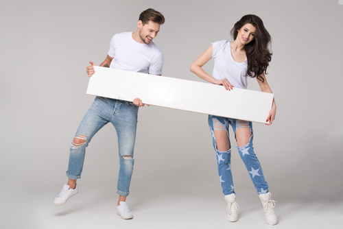 Happy couple holding white board Stock Photo 03
