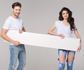 Happy couple holding white board Stock Photo 04