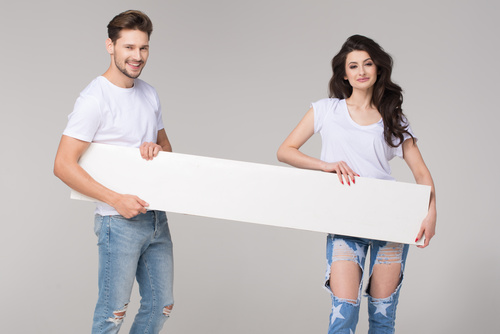 Happy couple holding white board Stock Photo 04