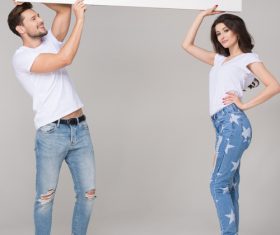 Happy couple holding white board Stock Photo 05