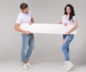 Happy couple holding white board Stock Photo 06