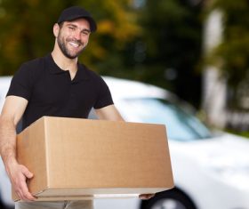 Smiling young delivery guy Stock Photo 02