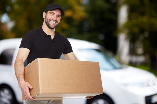 Smiling young delivery guy Stock Photo 02