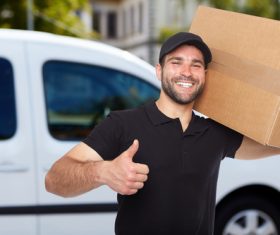 Smiling young delivery guy Stock Photo 03