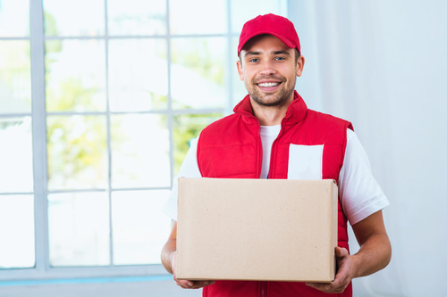 Smiling young delivery guy Stock Photo 04
