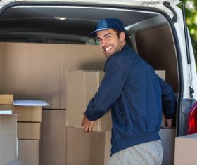 Smiling young delivery guy Stock Photo 05
