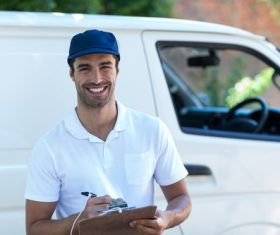 Smiling young delivery guy Stock Photo 06