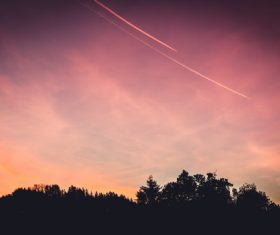 Stock Photo Airplane on the sky in dusk evening