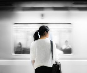 Stock Photo Asian girl waiting for the subway