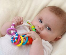 Stock Photo Baby holding rattle to play 01
