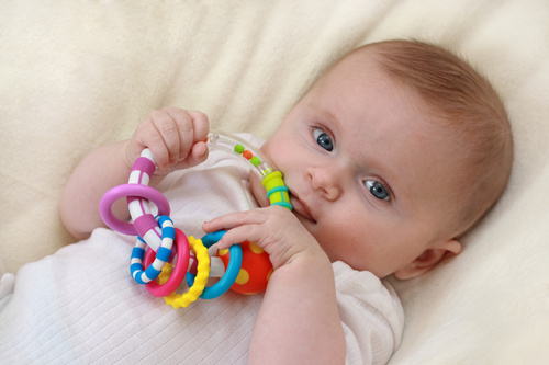 Stock Photo Baby holding rattle to play 01