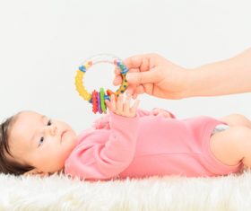 Stock Photo Baby holding rattle to play 09