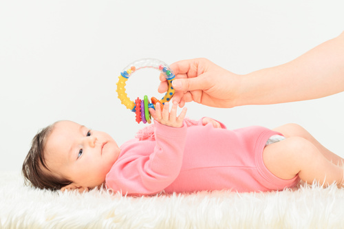 Stock Photo Baby holding rattle to play 09