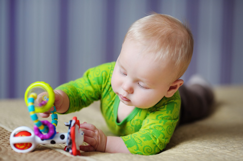 Stock Photo Baby holding rattle to play 10