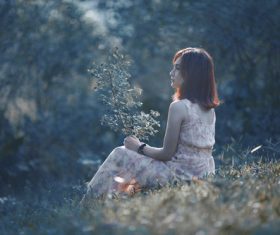 Stock Photo Beautiful girl holding branch