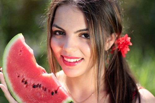 Stock Photo Beautiful girl holding watermelon in hand