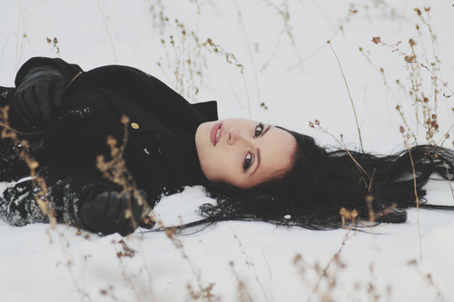 Stock Photo Beautiful woman lying on the snow