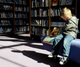 Stock Photo Children reading comic books in the library