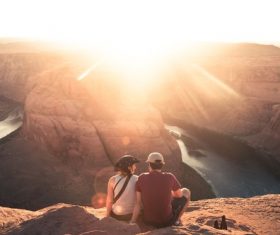 Stock Photo Couple sitting on high altitude looking at Horseshoe Bay scenery