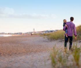 Stock Photo Father took walk with his child on the beach