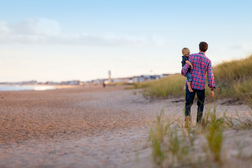 Stock Photo Father took walk with his child on the beach