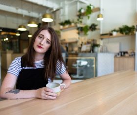 Stock Photo Girl drinking coffee in coffee shop