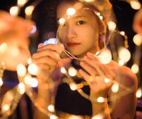 Stock Photo Girl holding colorful lights