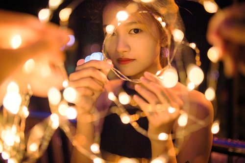 Stock Photo Girl holding colorful lights